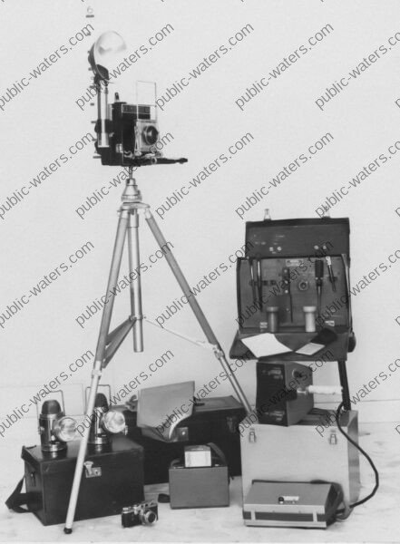 a black and white photo of a camera on a tripod