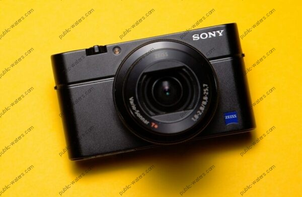 black Sony point-and-shoot camera on yellow surface