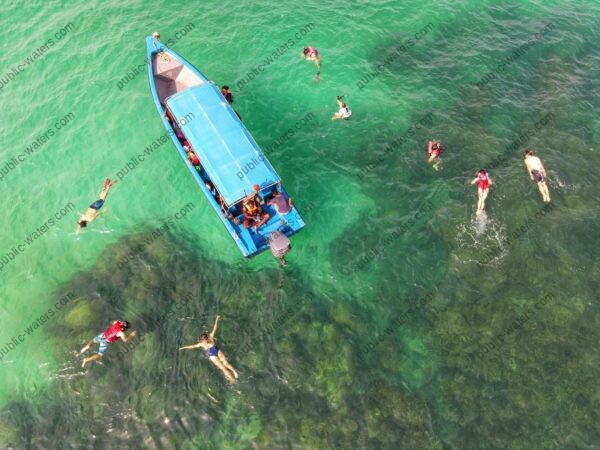 people in blue and white boat on body of water during daytime