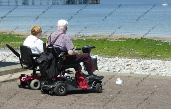 couple-on-scooters-by-the-beach