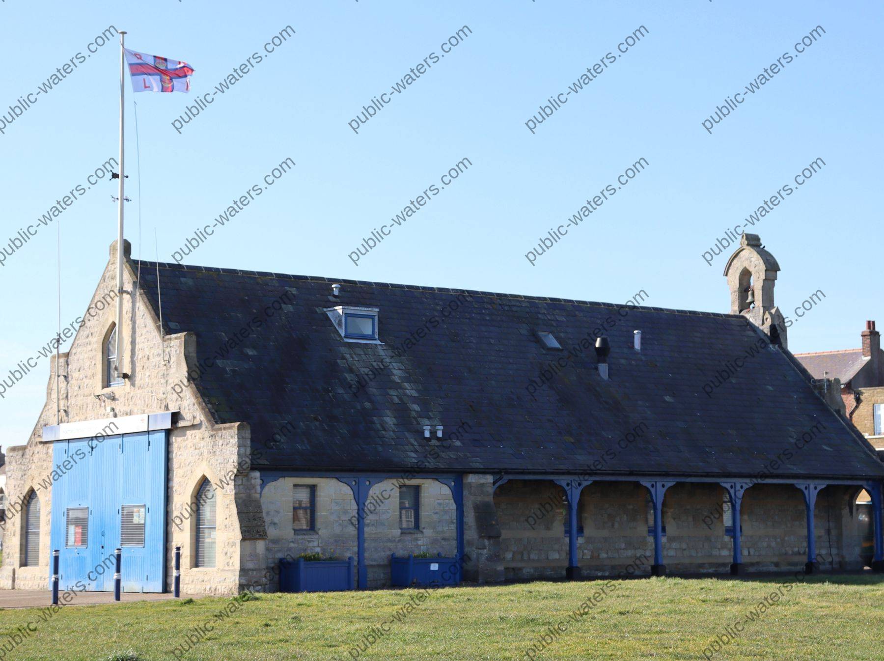 Walmer Lifeboat Station side view and bench seating area with shelter over looking the bandstand